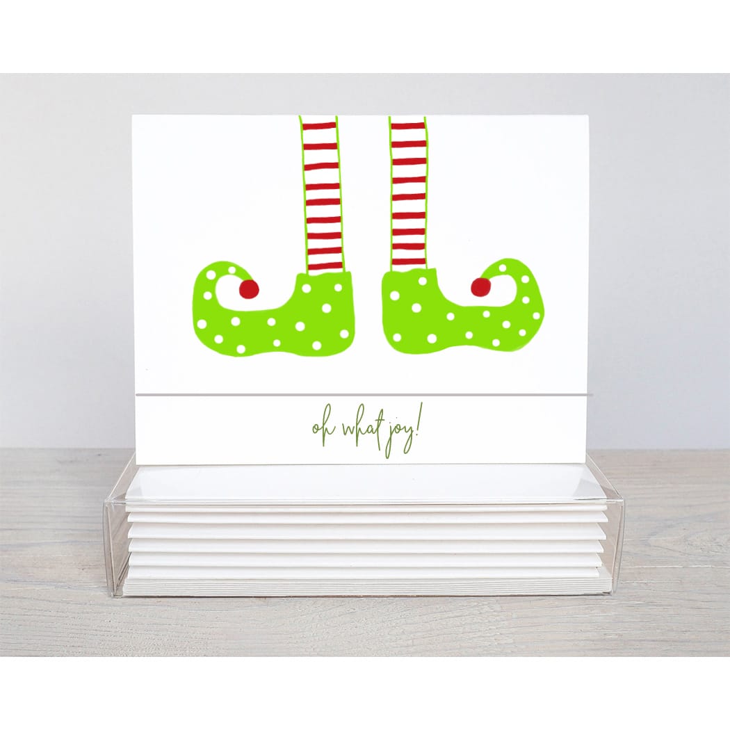 ELF LEGS HANGING from the too of the holiday note card with the words, oh what joy! seen on the inside and outside of the card.