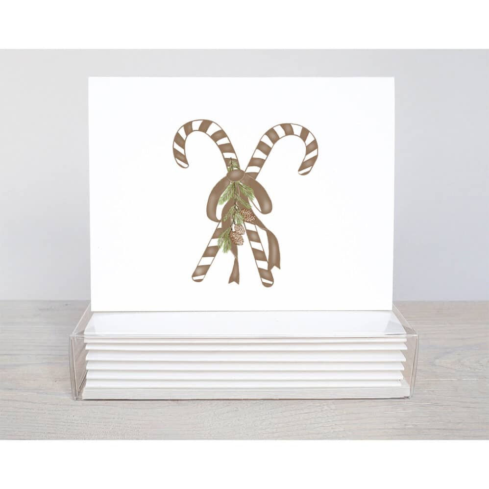 chocolate candy cane holiday note card. Two brown and white striped candy canes tied with a brown bow. White pine cones hang from the bow.